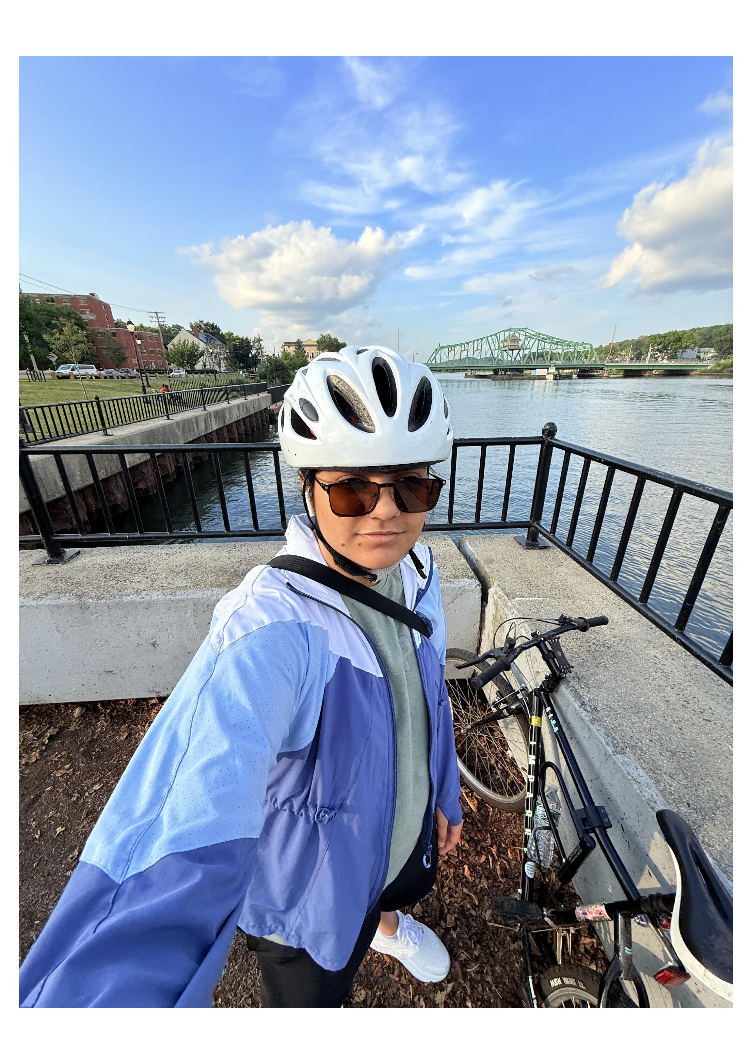 Kavya biking by the water